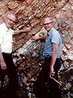 Luis Alvarez and his son, Walter Alvarez, pointing out the K-T bounary in Gubbio, Italy.